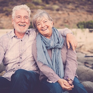 Older couple smiling together outside