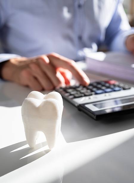 Dental patient calculating cost of dental treatment