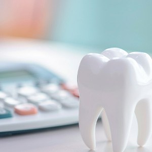 Tooth and calculator (Does Dental Insurance Cover Tooth Extractions?