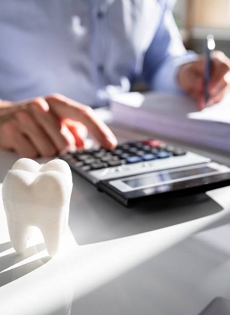 patient calculating cost of dentures in Manchester