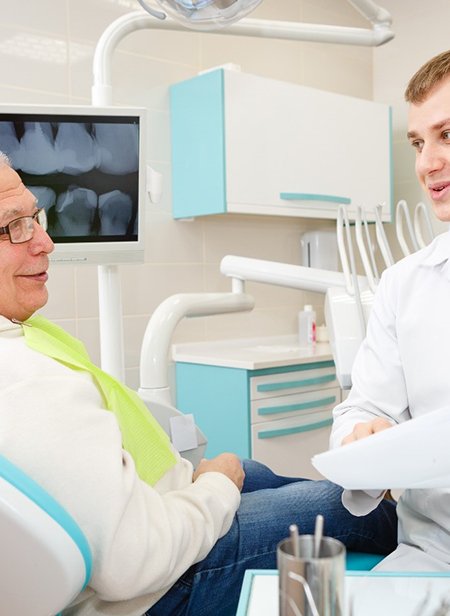 Dentist explaining the process of receiving dentures in Manchester