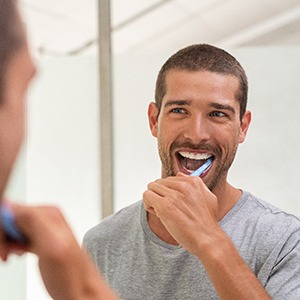 smiling dentist holding a piggy bank