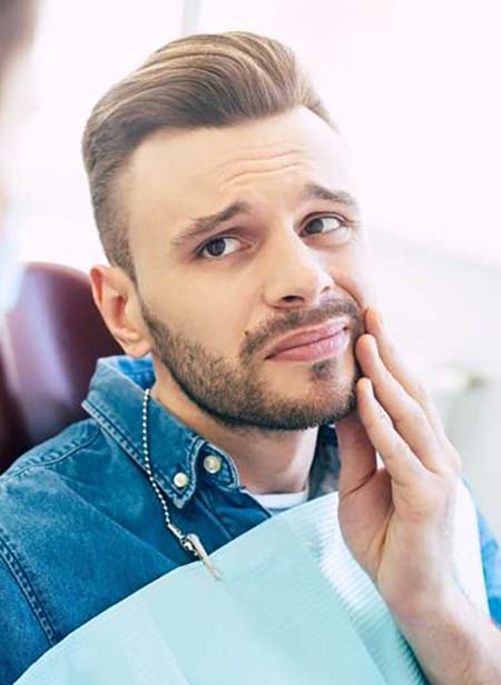 Man visiting an emergency dentist in Manchester for care