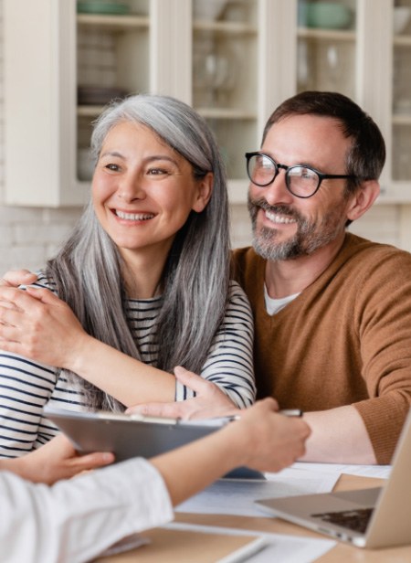 couple smiling discussing dental financing