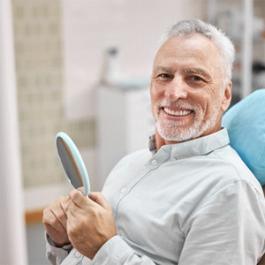 patient smiling after getting dental implants in Manchester