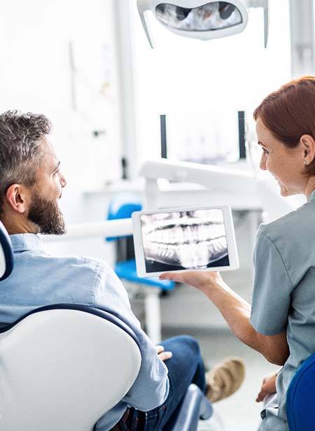 Dentist discussing the cost of dental implants in Manchester with patient