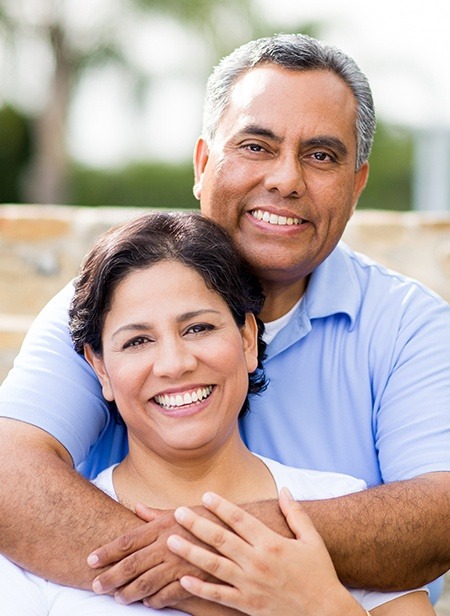 Man and woman with dentures smiling