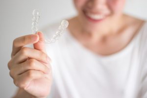 Woman smiling after using Invisalign in Manchester