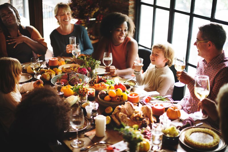 family smiling during Thanksgiving dinner