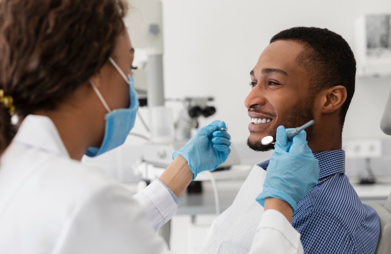 Patient smiling with their dental crown