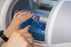 Dentist putting block of ceramic into CEREC milling machine
